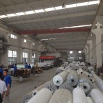 Rolls of raw material, and behind another lamination process